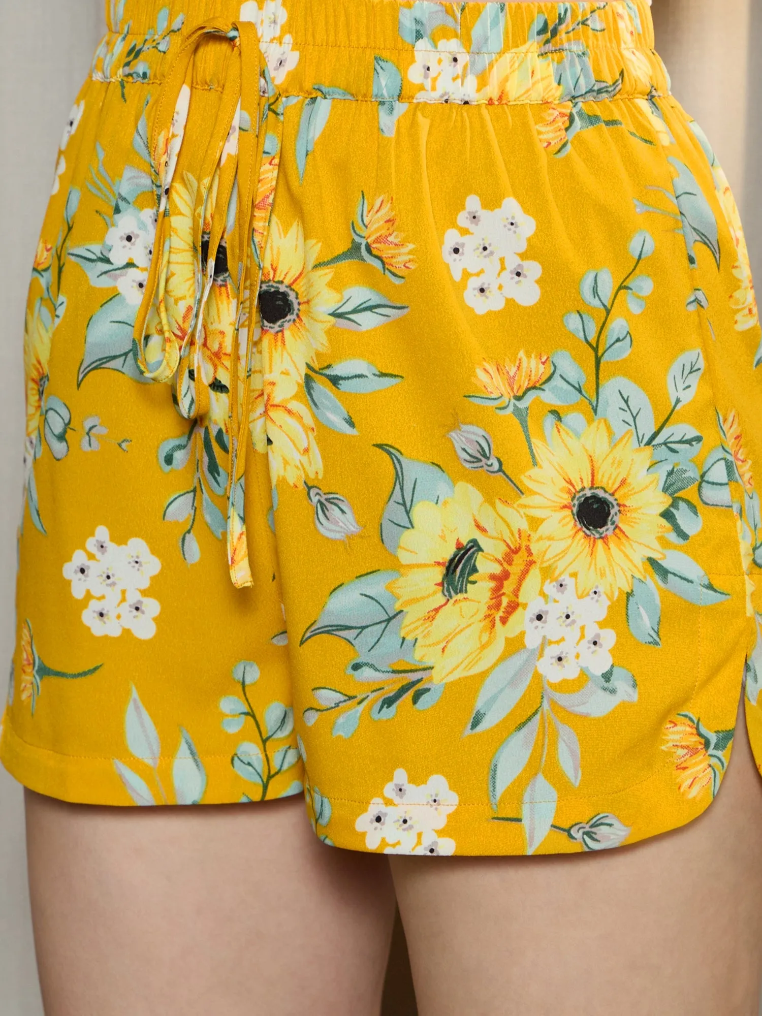 Berrylush Women Yellow & Green Floral Printed High-Rise Elastic Waist Tie-Up Side-Slit Mini Summer Hot Pants