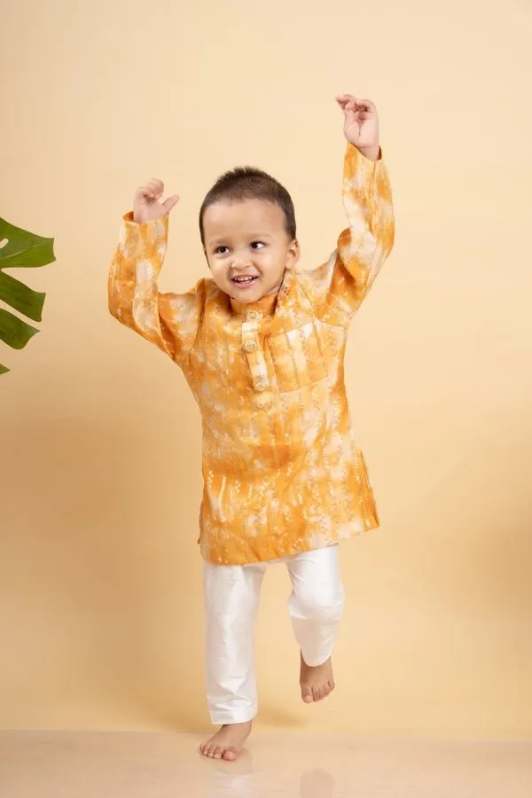 Bright orange tie-dye kurta with classic white pants for a cheerful and festive look