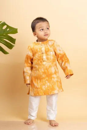 Bright orange tie-dye kurta with classic white pants for a cheerful and festive look