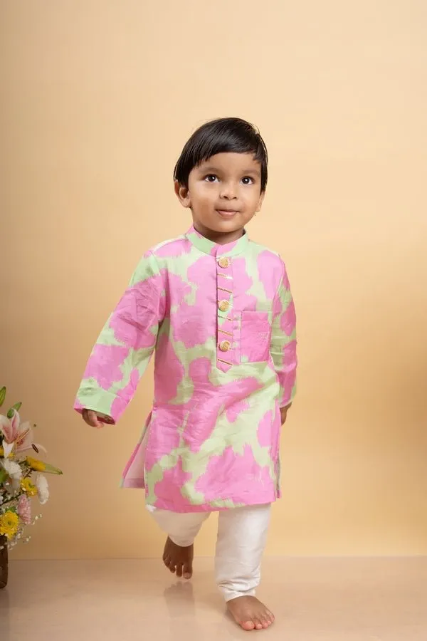 Vibrant pink and green tie-dye kurta paired with classic white pants for a playful yet elegant festive look