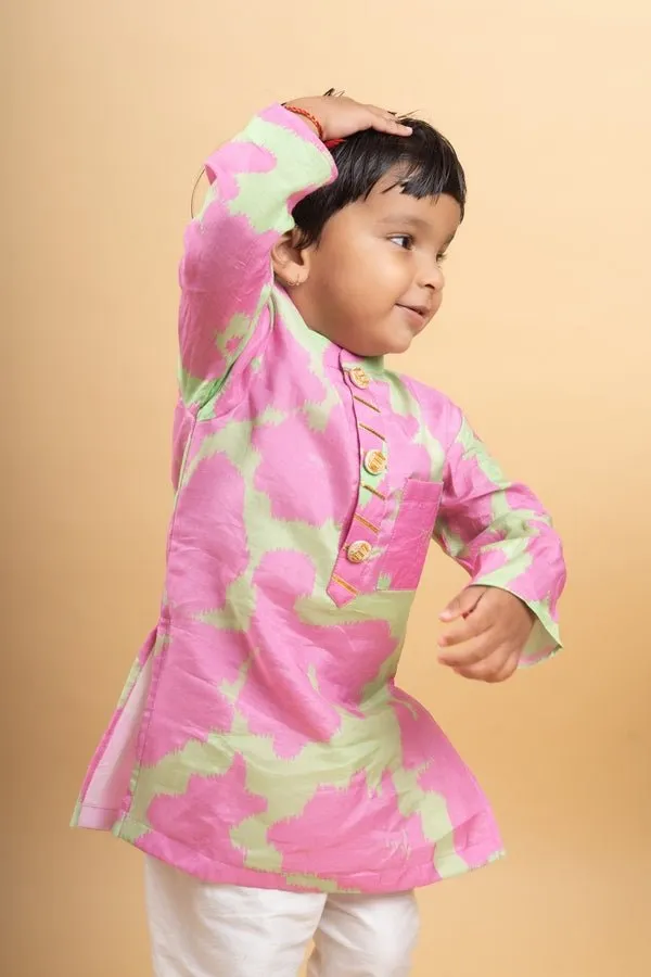 Vibrant pink and green tie-dye kurta paired with classic white pants for a playful yet elegant festive look